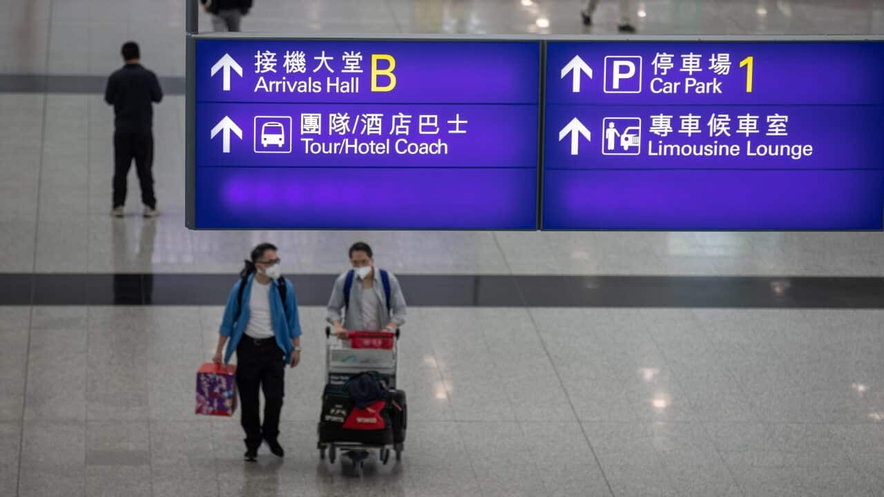 Passengers walk in the arrival hall at Hong Kong International Airport.