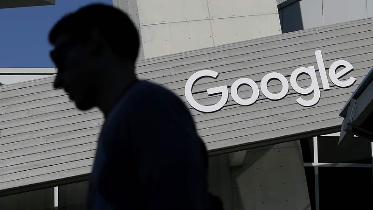A man walks past a building on the Google campus in Mountain View