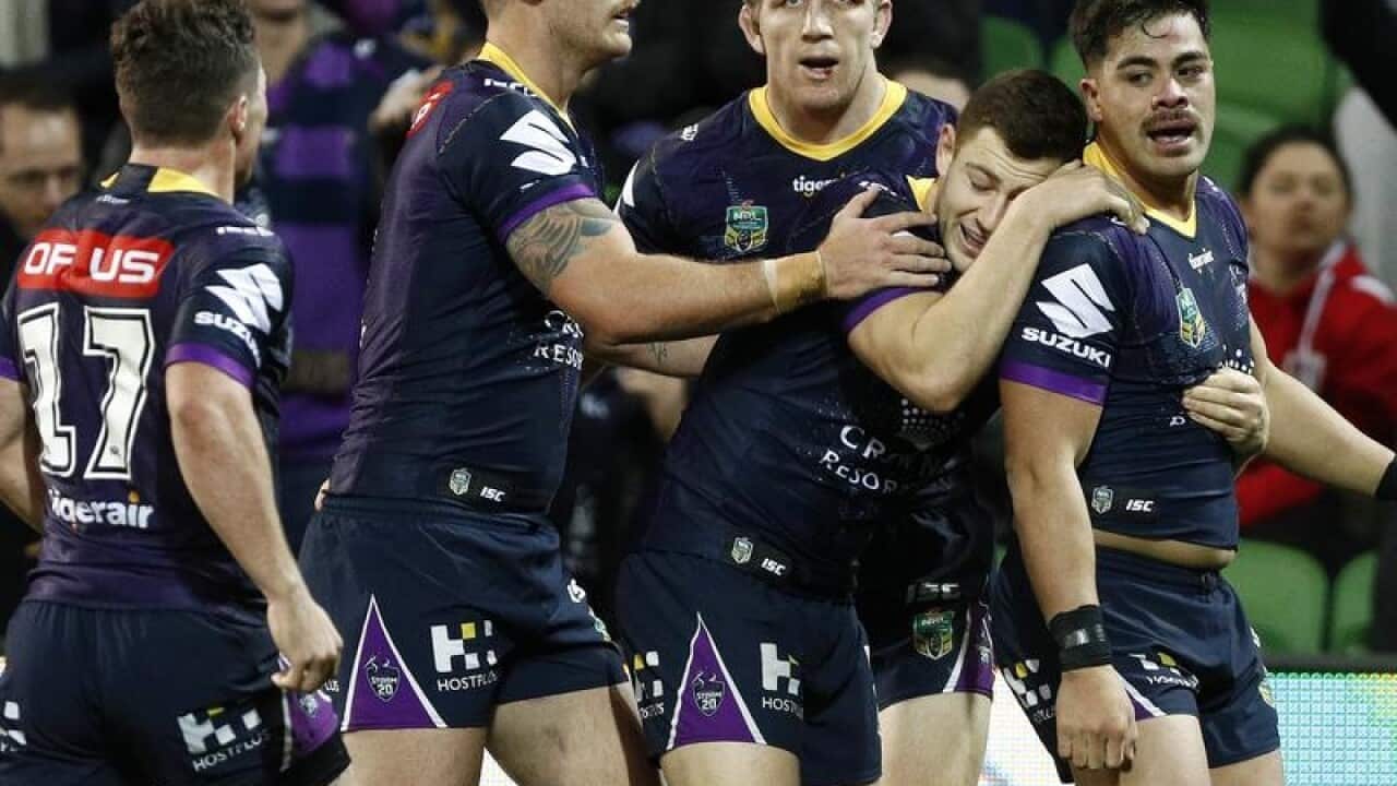Storm players celebrate after scoring a try