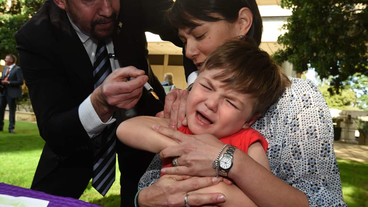 A three-year-old boy receives a vaccination