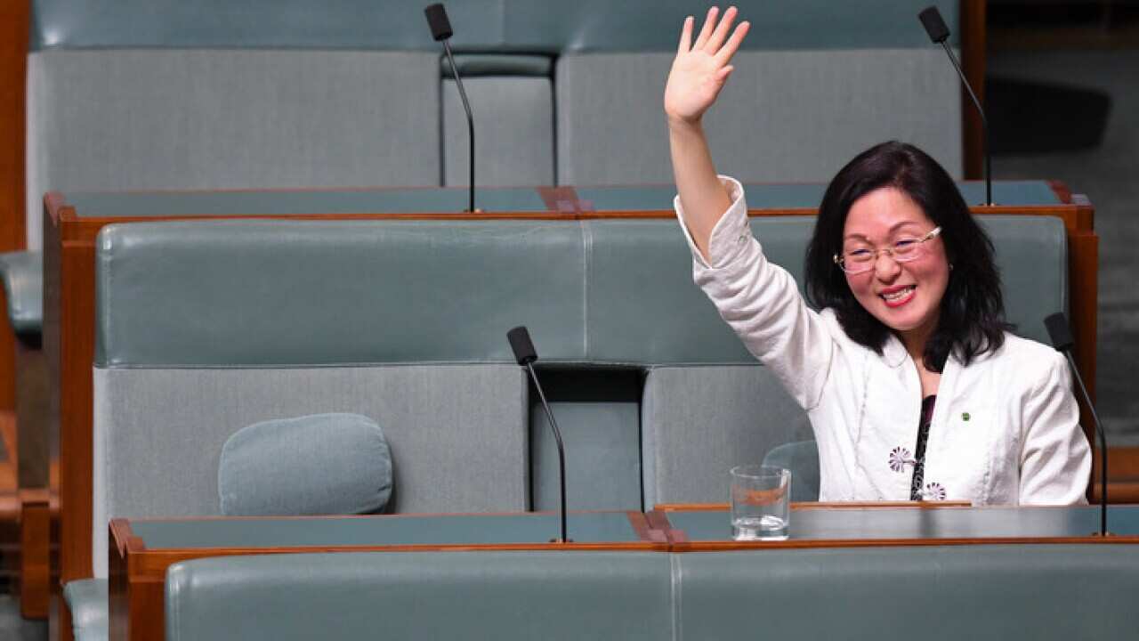 The Member for Chisholm Gladys Liu waves after delivering her maiden speech in the House of Representatives