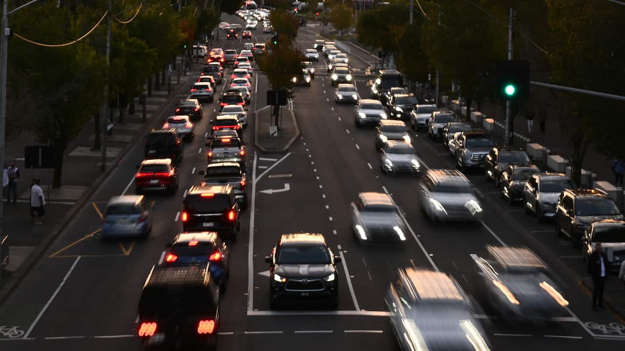 A busy multilane road with cars crossing an intersection