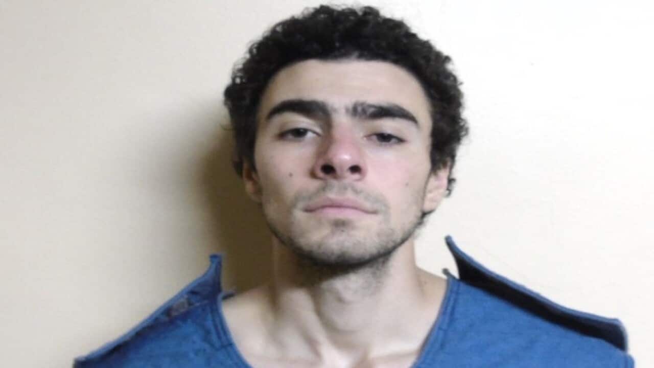 A man wearing a blue top