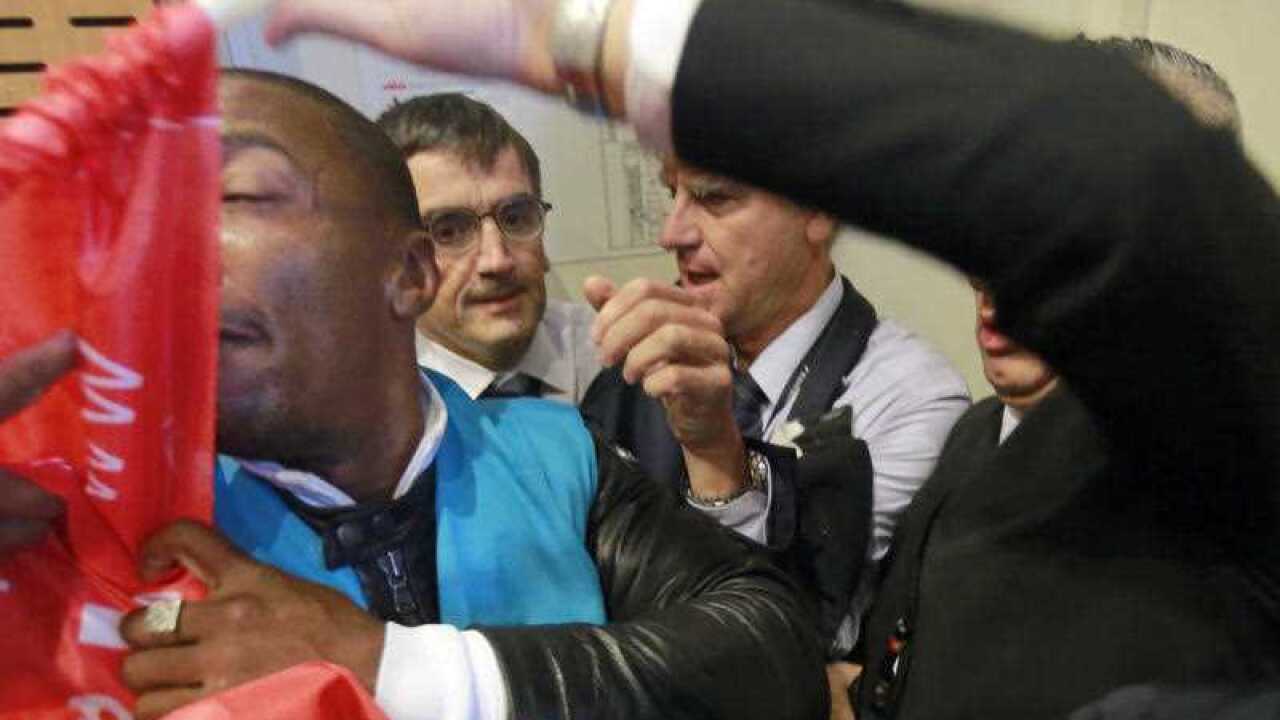 Security guards protect Air France directors from protesters.