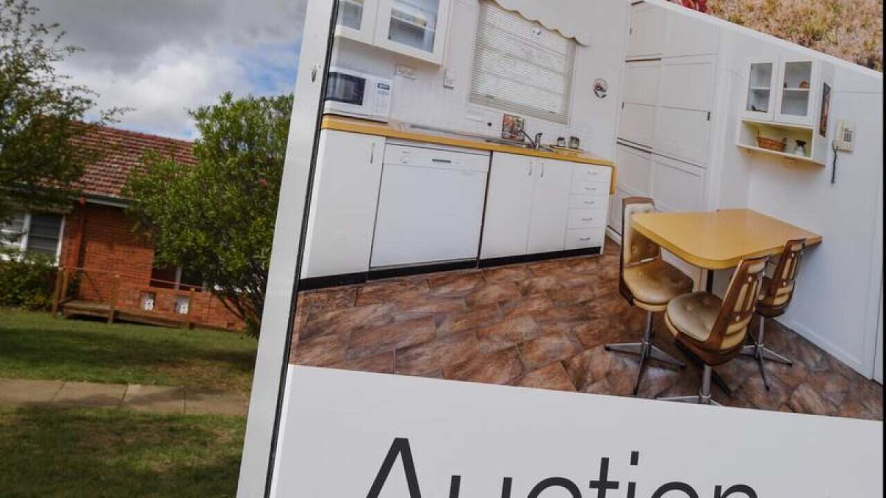 A real estate advertising board outside a home in Canberra