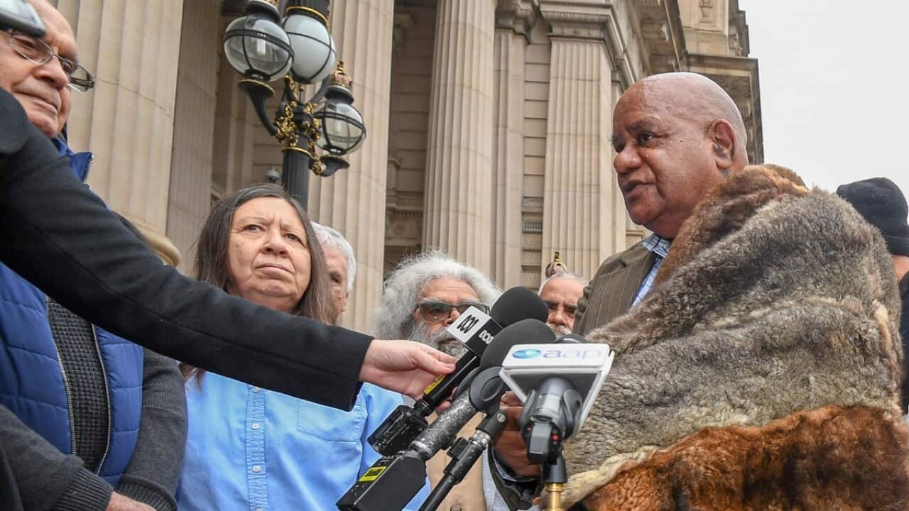 Clan Elders stand on the steps of parliament