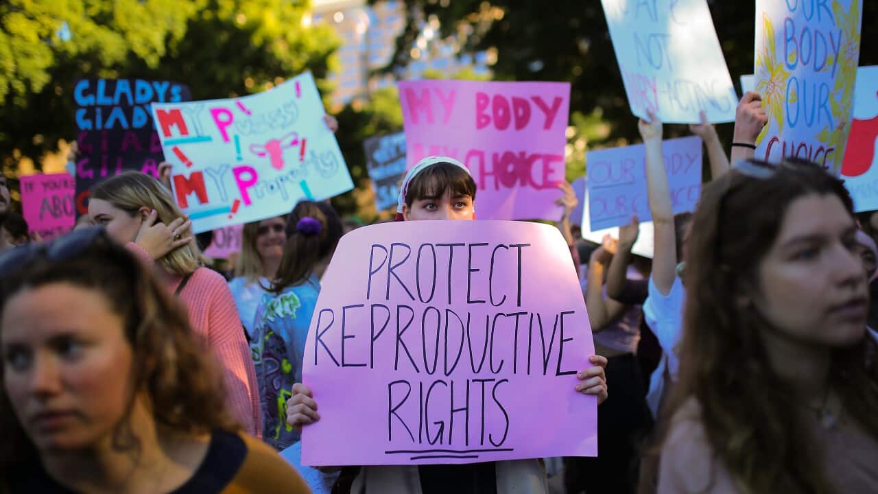 Protesters hold placards during the Our Body Our Choice march in Sydney, Sunday, June 9, 2019. (AAP Image/Steven Saphore) NO ARCHIVING