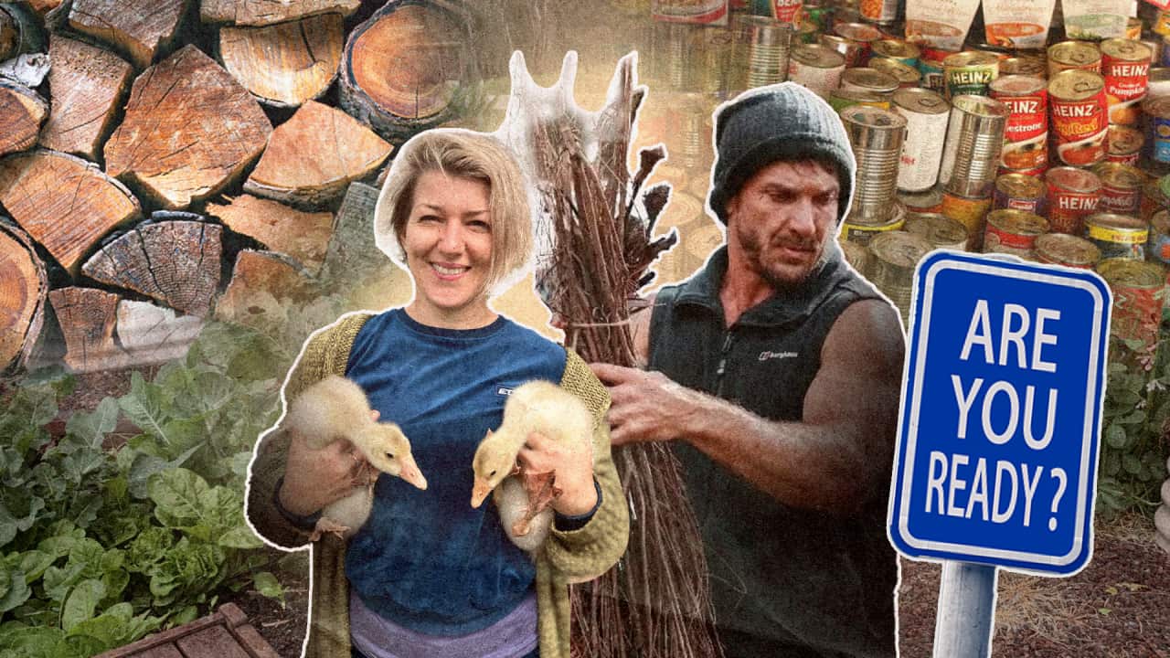 A woman holding ducks and a man holding sticks. In the background are soup cans, firewood and a sign that says 'ARE YOU READY?'.