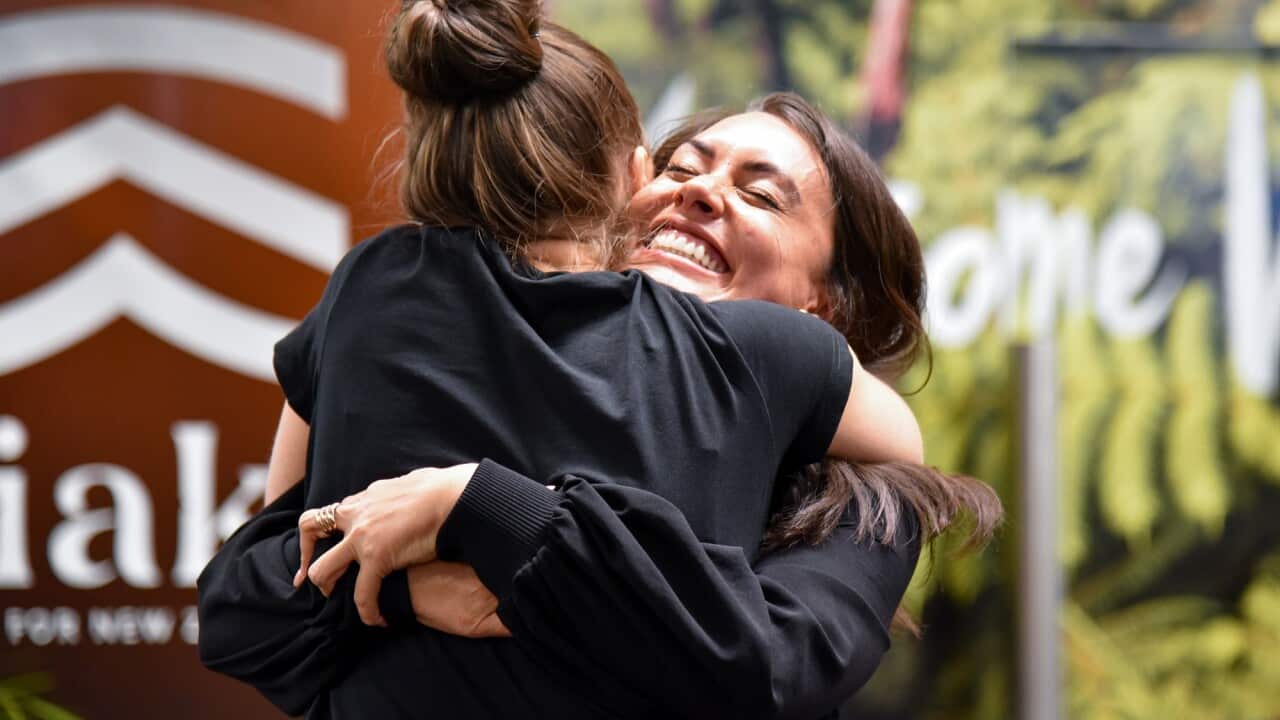Families and loved ones embrace after landing on the first Air New Zealand flight to land in Wellington on 19 April 2021.