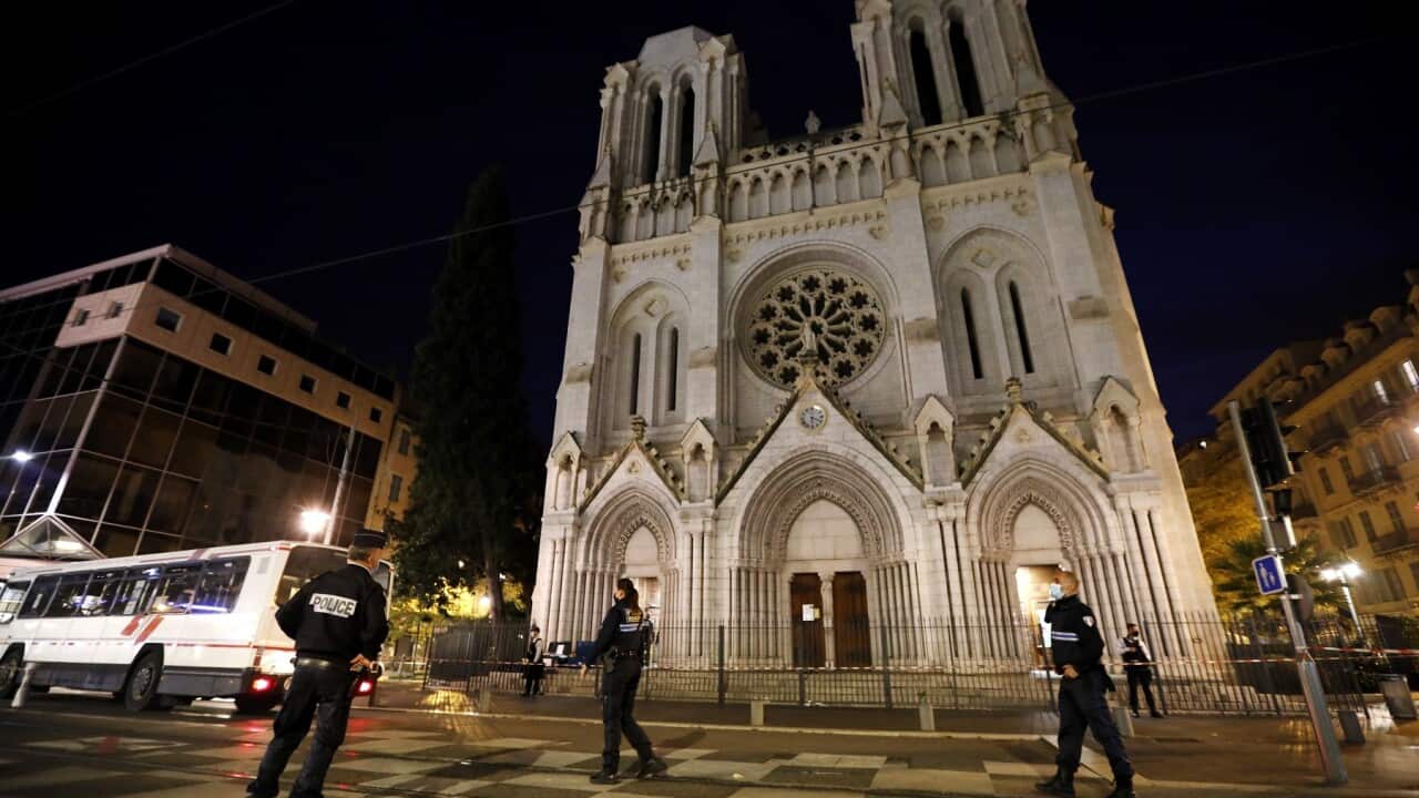 French police officers secure the street near the entrance of the Notre Dame Basilica church in Nice
