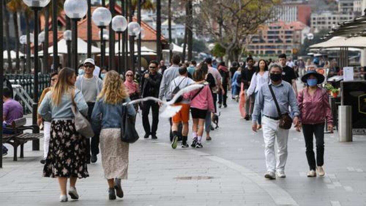 People wear face masks in Circular Quay in Sydney, Australia.