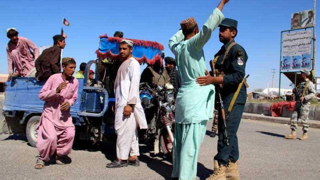 Afghan security officials check people and vehicles  as security has been intensified ahead of parliamentary elections in Helmand.