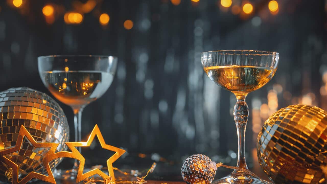 New Year celebration concept with golden lights and champagne flute