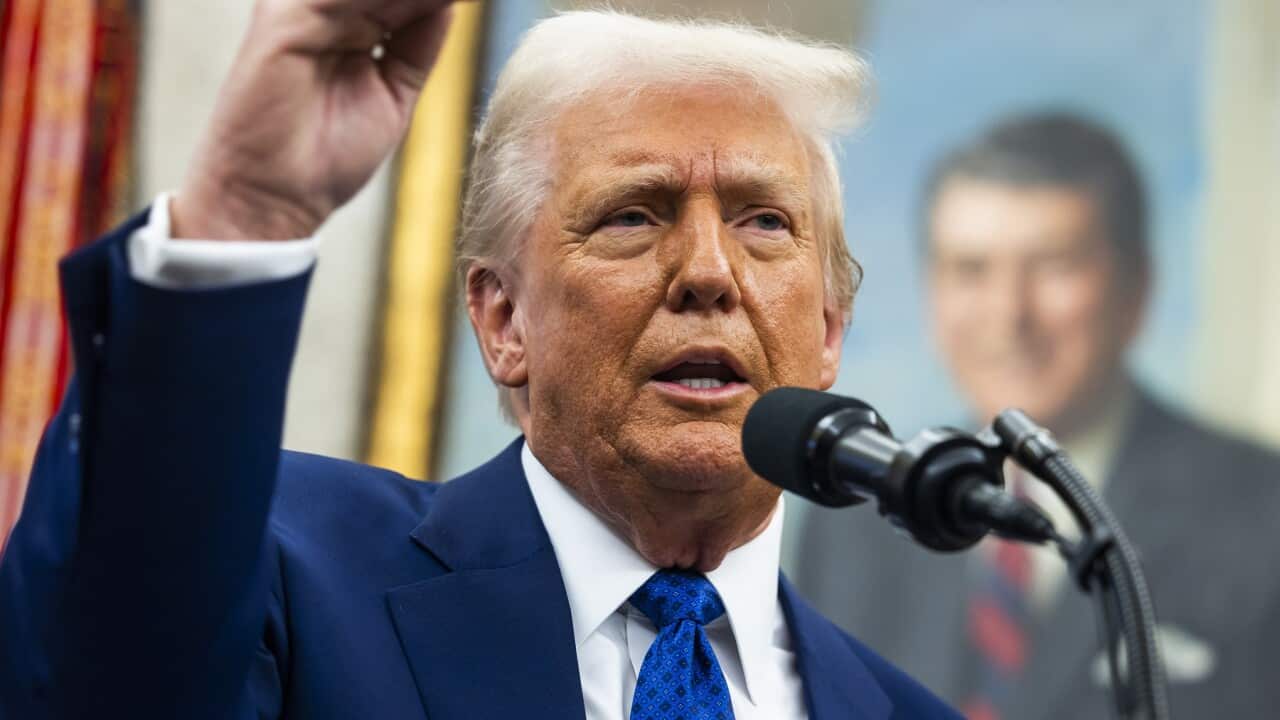 US President Donald Trump speaks to the media in the Oval Office of the White House in Washington.