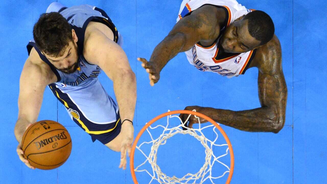 Memphis Grizzlies player Marc Gasol (C) of Spain goes to the basket
