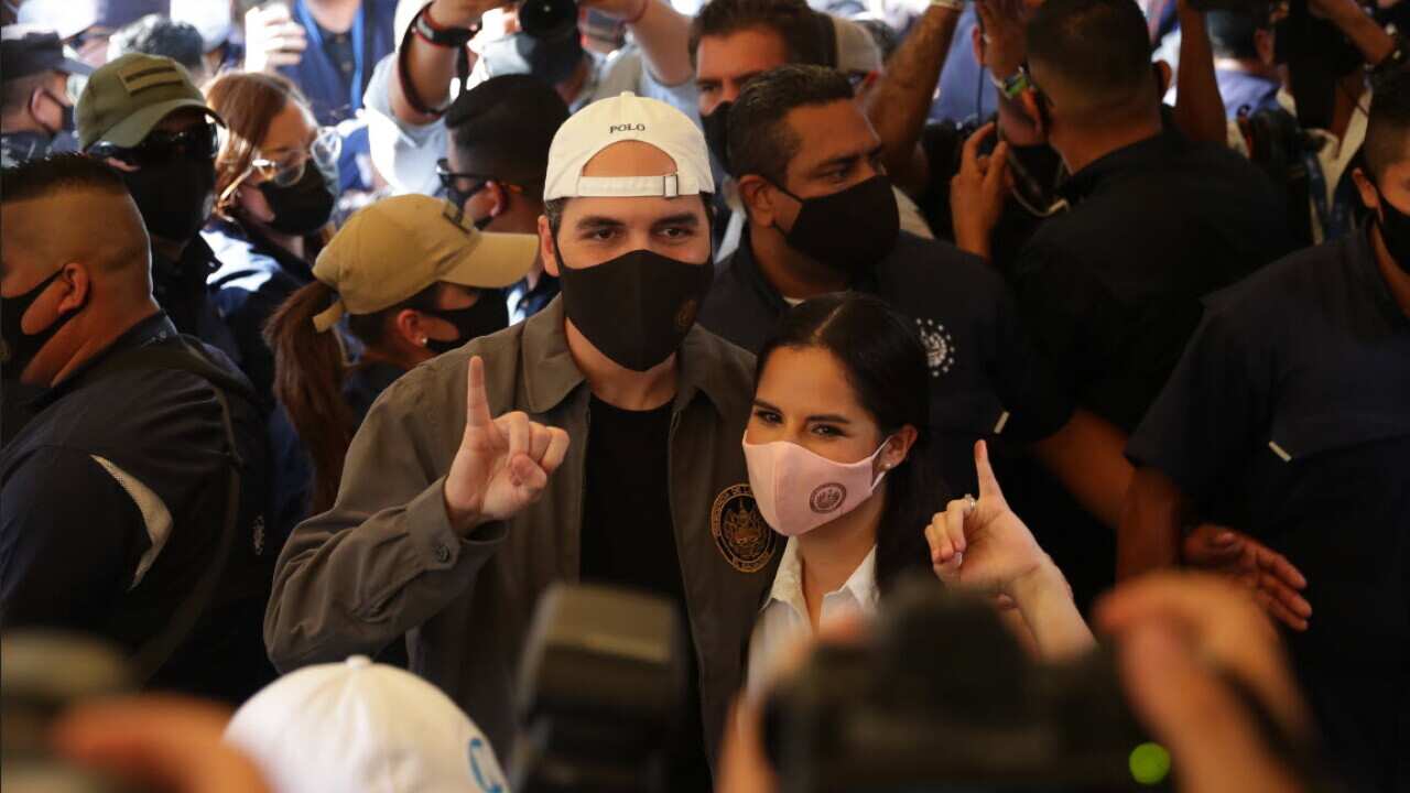 El Salvador’s President, Nayib Bukele, arrives with his wife, Gabriela Rodriguez, to cast his vote at a polling station in San Salvador. (AAP)