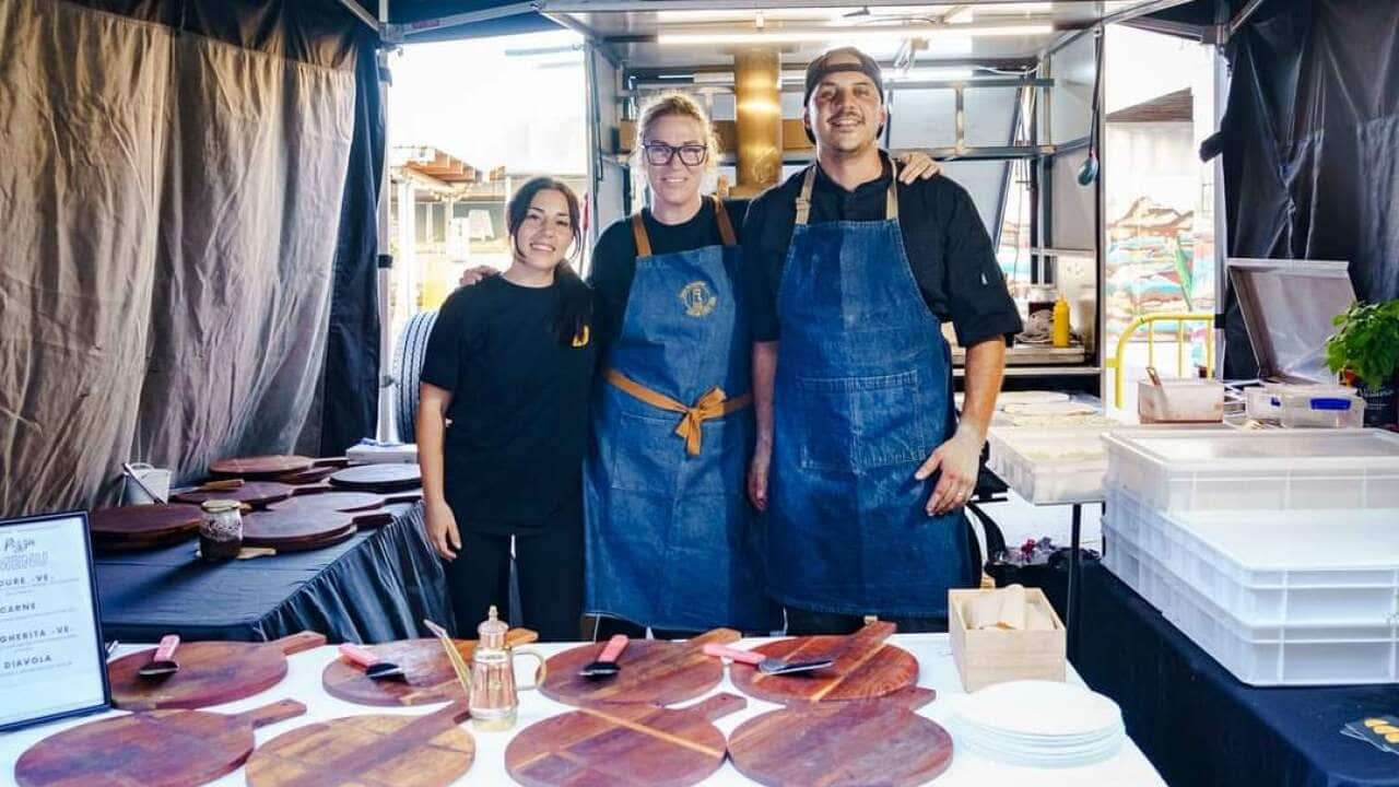 Faty, Jessica and Daniele in their stand
