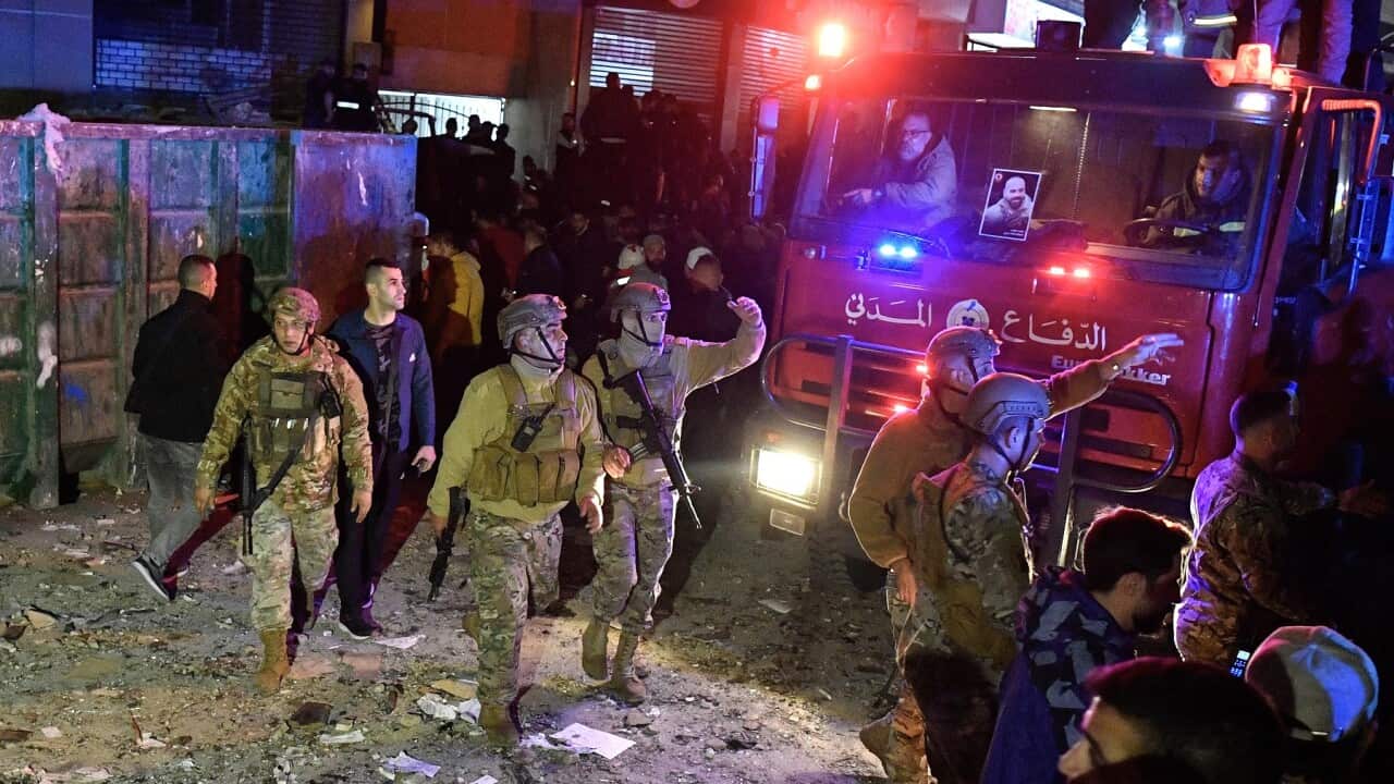 Lebanese soldiers walk at the site of an explosion in the southern district of Dahiyeh, Beirut (AAP)
