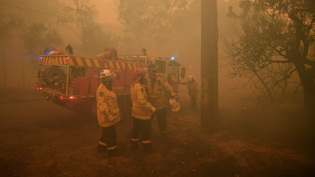 NSW Rural Fire Service crews work to protect a property at Kulnura.