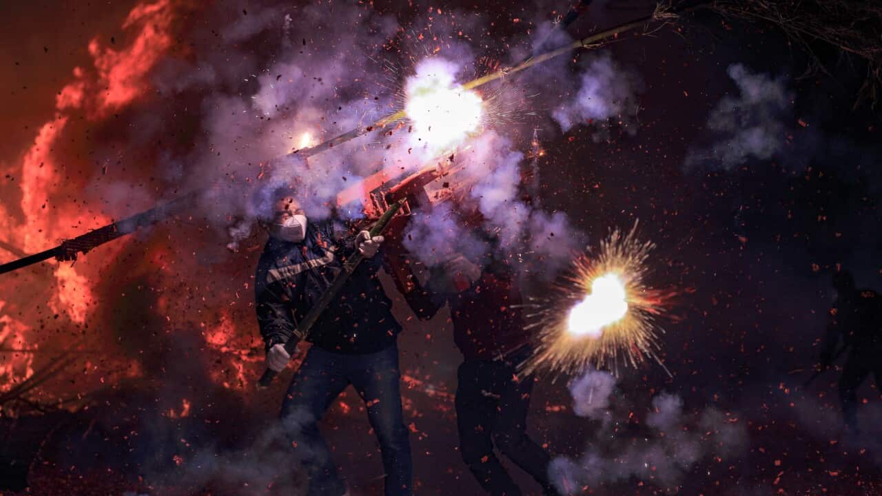 Villagers in Guangdong Province carry out a Lunar New Year ritual with fire crackers