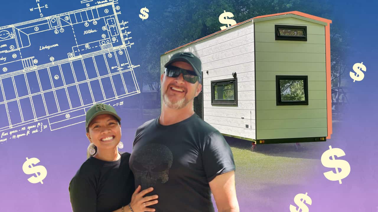 A man and woman wearing black t-shirts smile with their arms around one another. In the background there is a white clad tiny home, building plans and dollar signs.