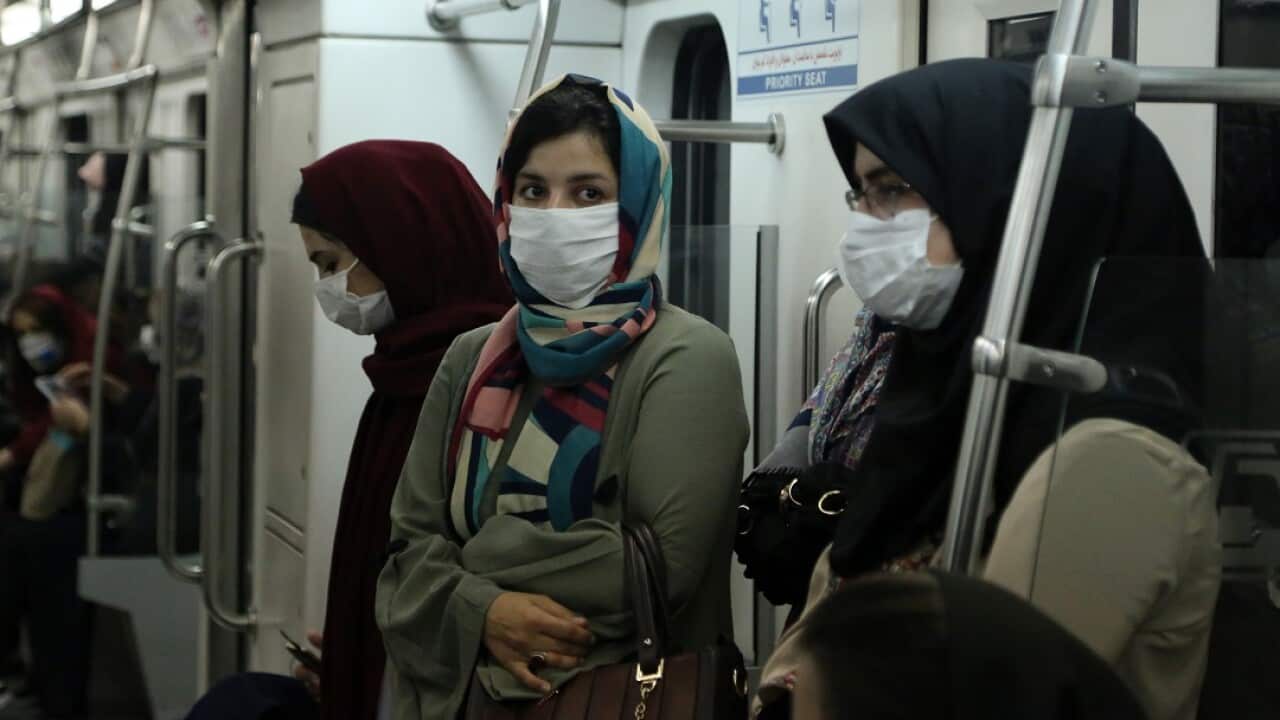 People wear masks on a subway in Tehran, Iran.