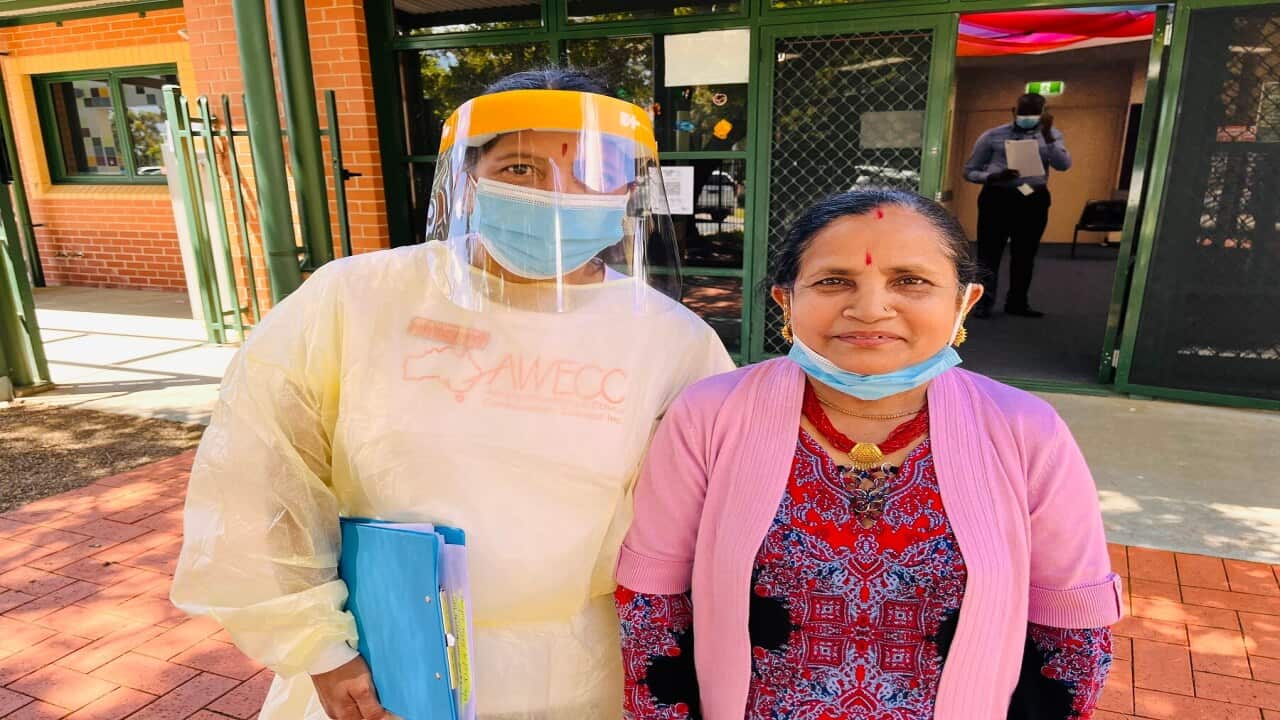 AWECC community worker Bhakti Mainali Dhamala with Bhutanese community member Ganga Khanal (SBS-Abby DInham)