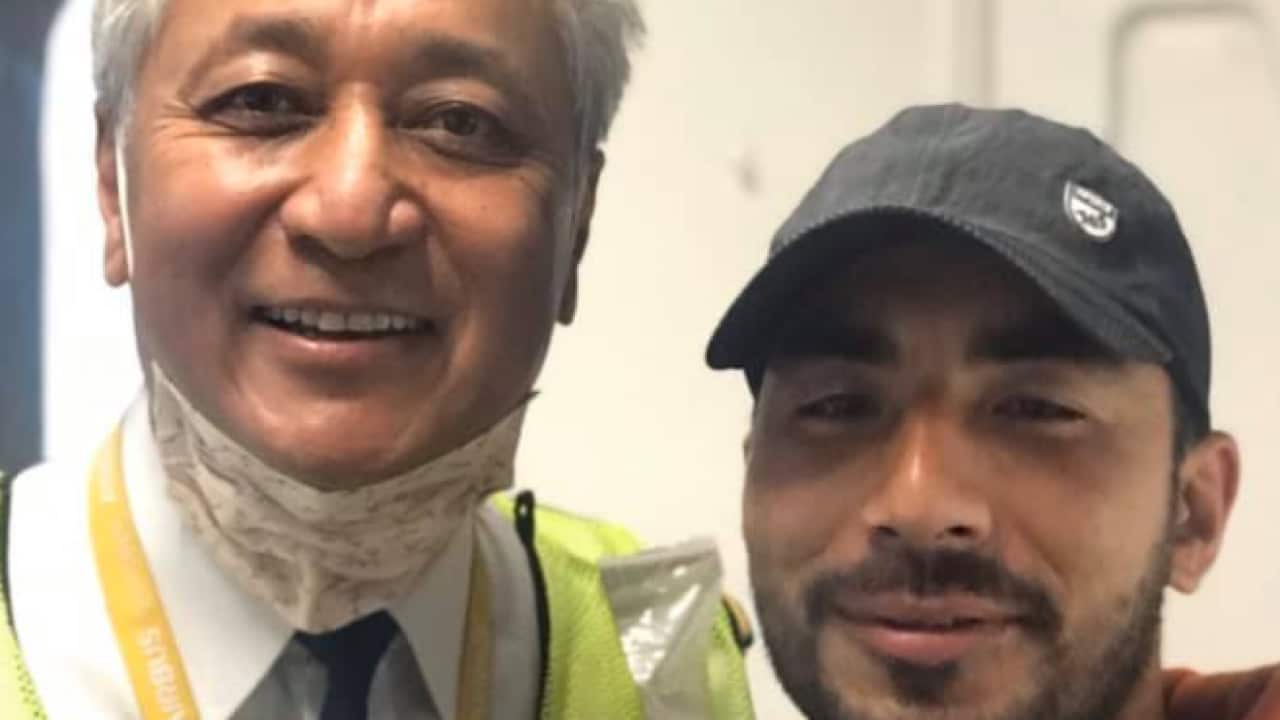 Sydney resident Om Krishna Shrestha (right) with Nepal Airlines Pilot Vijay Lama during the COVID-19 evacuation flight from Kathmandu to Brisbane