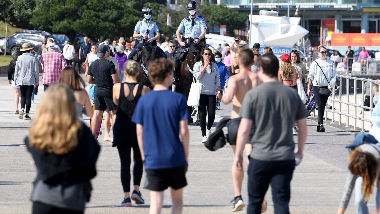 Police are seen patrolling Bondi Beach on horseback in Sydney.
