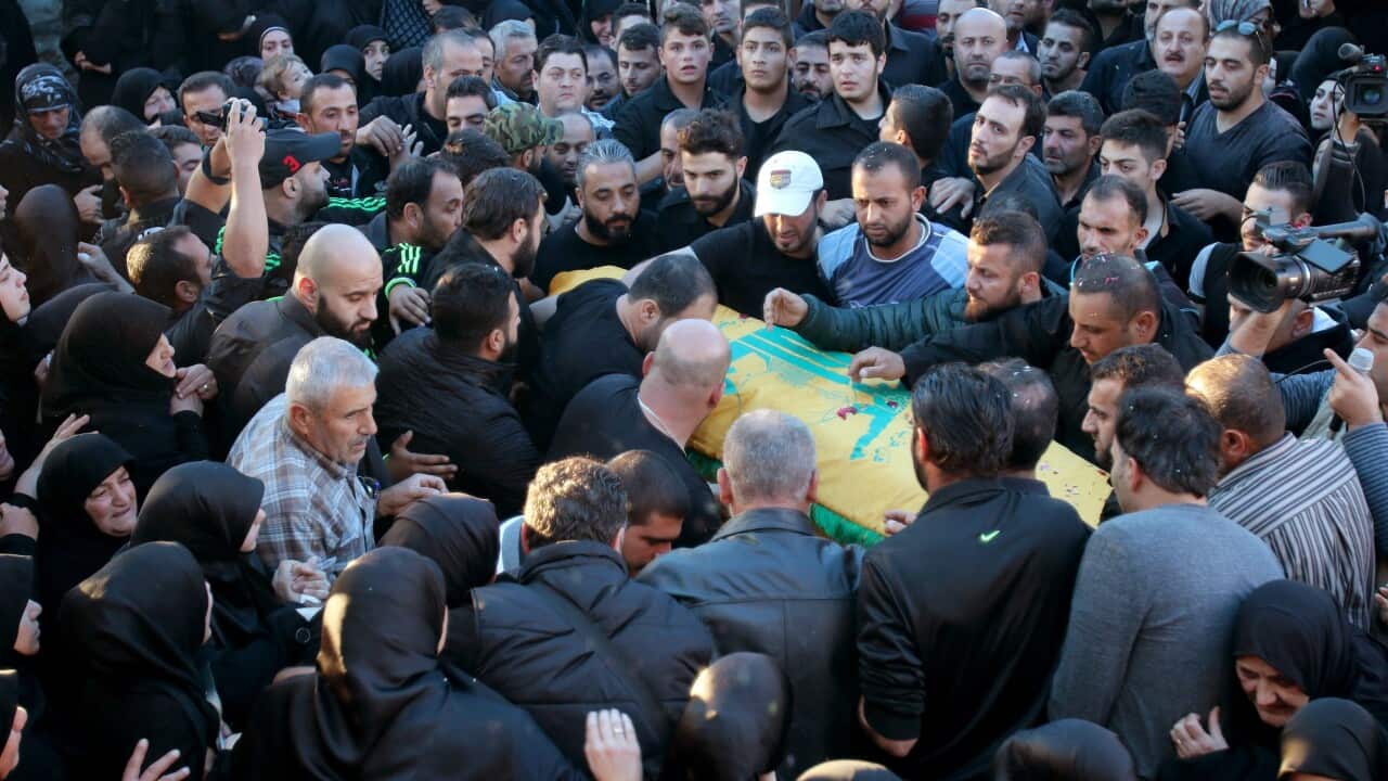 Lebanese mourners, relatives and friends carry the coffin of Adel Tormos, who had tried to stop the bomber from entering the Shiites mosque full of worshipers. (EPA)