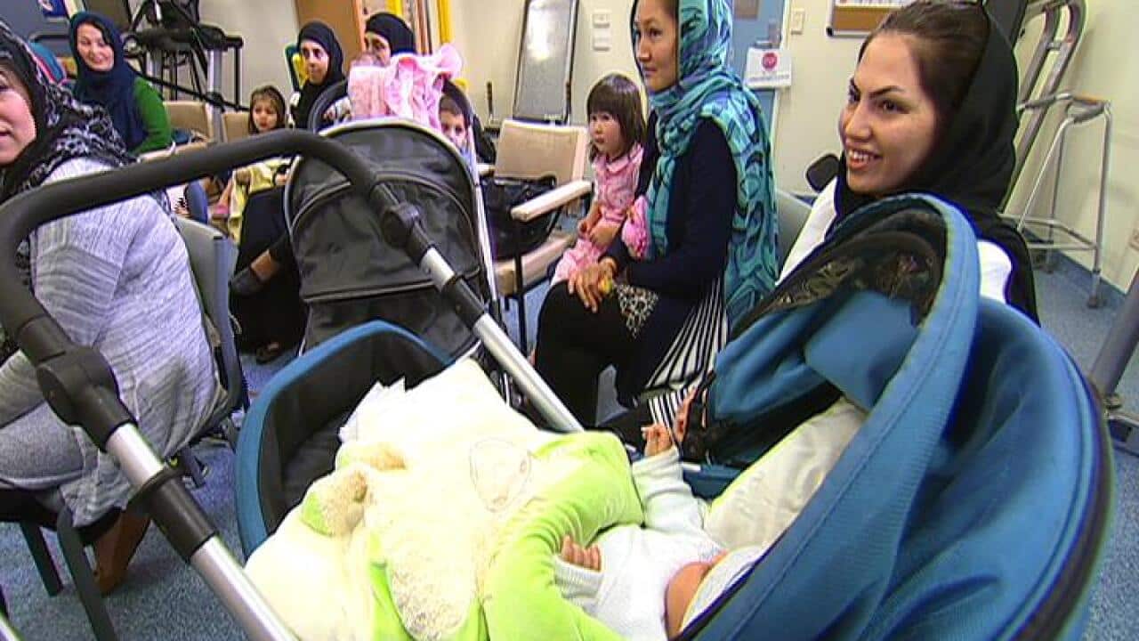 Migrant women wait at a practice.