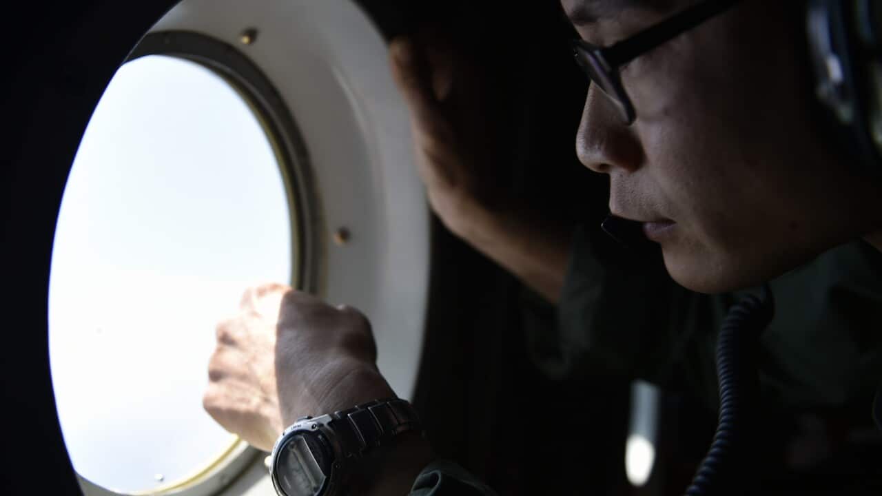 man looking out window