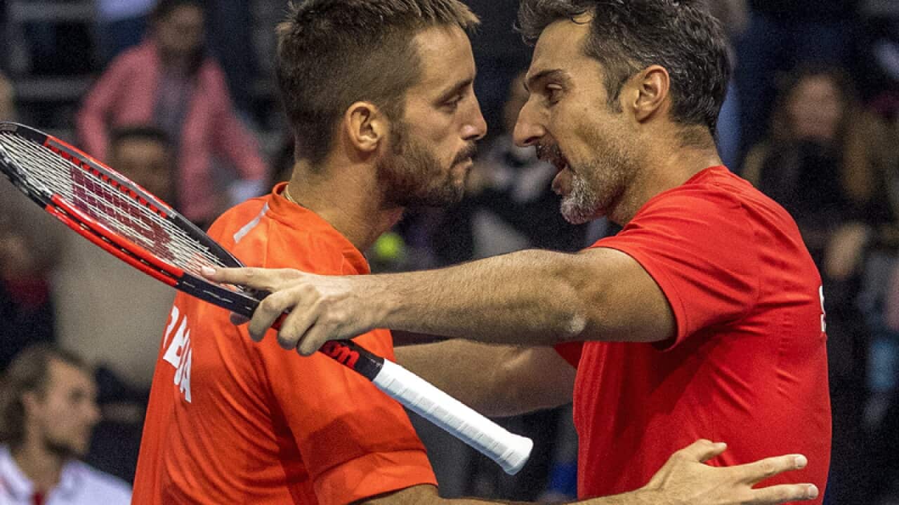 Viktor Troicki (L) and Nenad Zimonjic (R) of Serbia celebrate