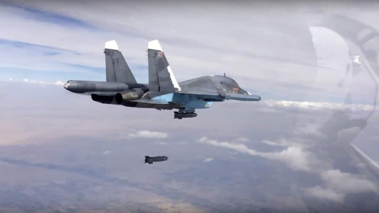 A bomb is released from Russian Su-34 strike fighter in Syria. Hundreds of Iranian troops are being deployed in northern and central Syria