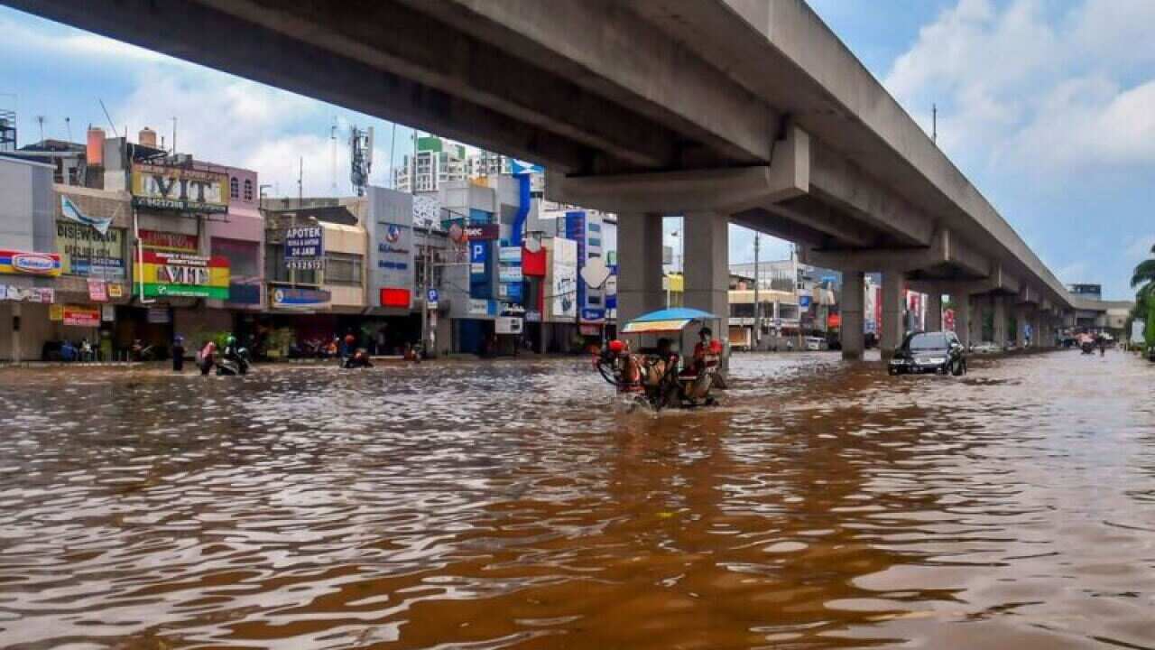 A horse pulls a carriage through a flooded road in Jakarta on Jan. 1, 2020.