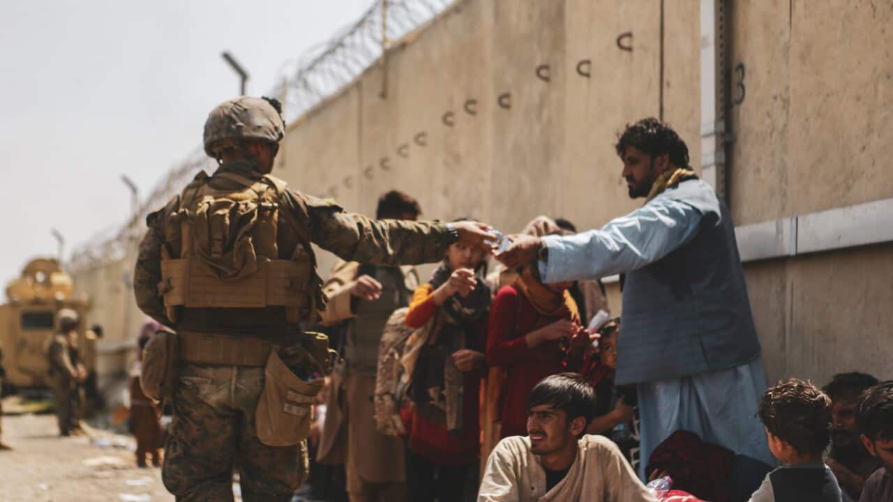 A Marine with the 24th Marine Expeditionary unit (MEU via Sipa USA) passes out water