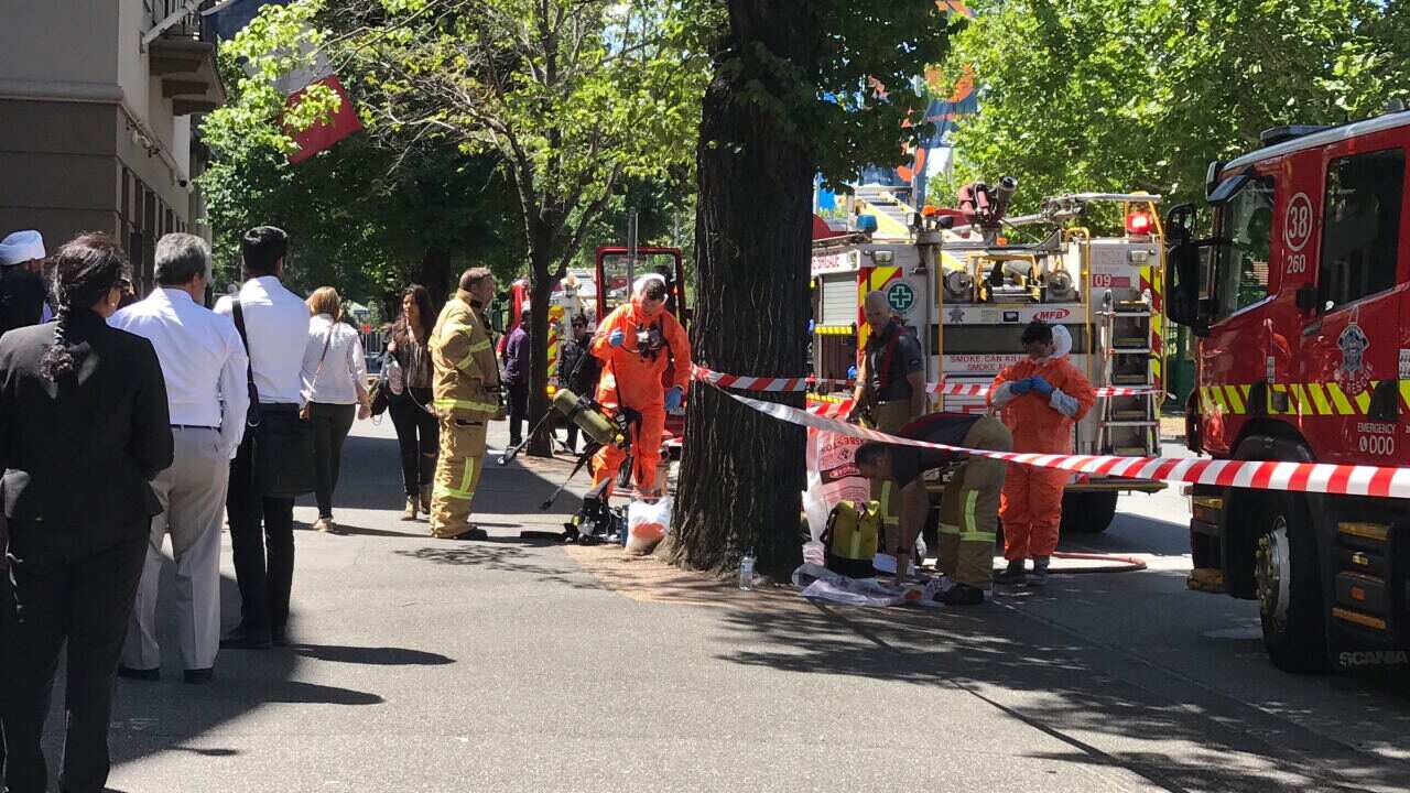 Hazmat and fire crews are seen outside the Indian and French Consulates on St Kilda Road in Melbourne.