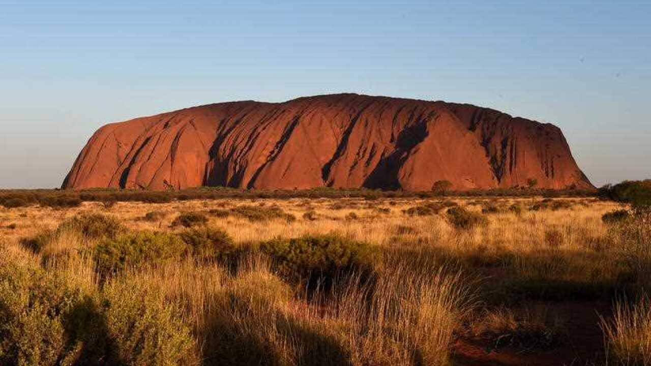 Uluru, pictured in afternoon light, in the Northern Territory, Saturday, Oct. 24, 2015. On Monday, October 26, Aboriginal traditional owners will mark 30 years since they won back Uluru and Kata Tjuta from the federal government. (AAP Image/Dan Peled)