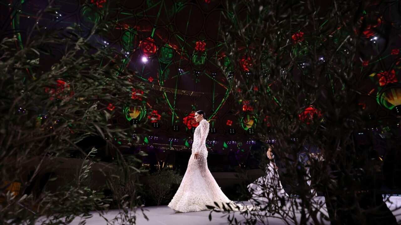 A model takes to the catwalk during the Sustainable Fashion show as part of COP28 at Expo City Dubai in Dubai.jpg