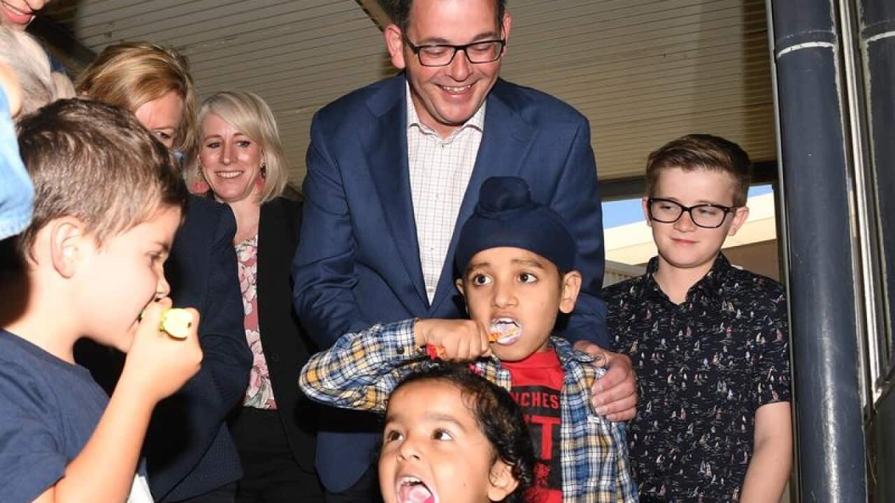 Victorian Premier Daniel Andrews with kids brushing their teeth