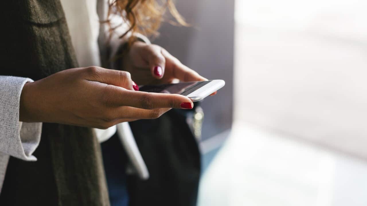 Close-up of woman text messaging
