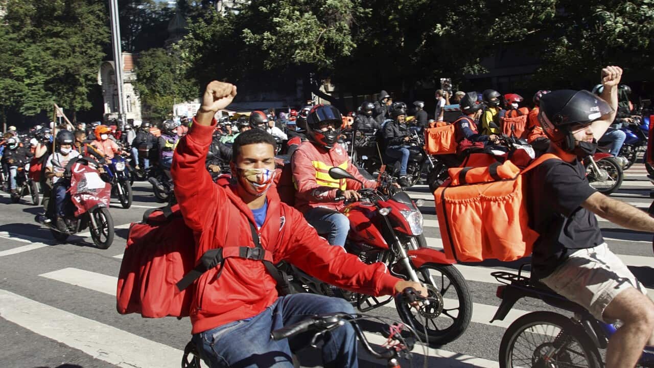 Delivery app workers take part in a protest to demand better working conditions in São Paulo