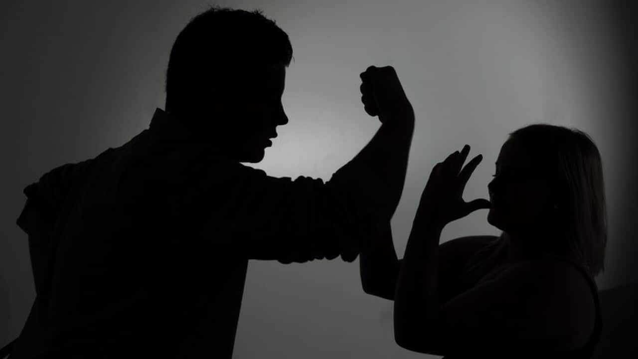 A silhouette of a man threatening a woman (AAP).