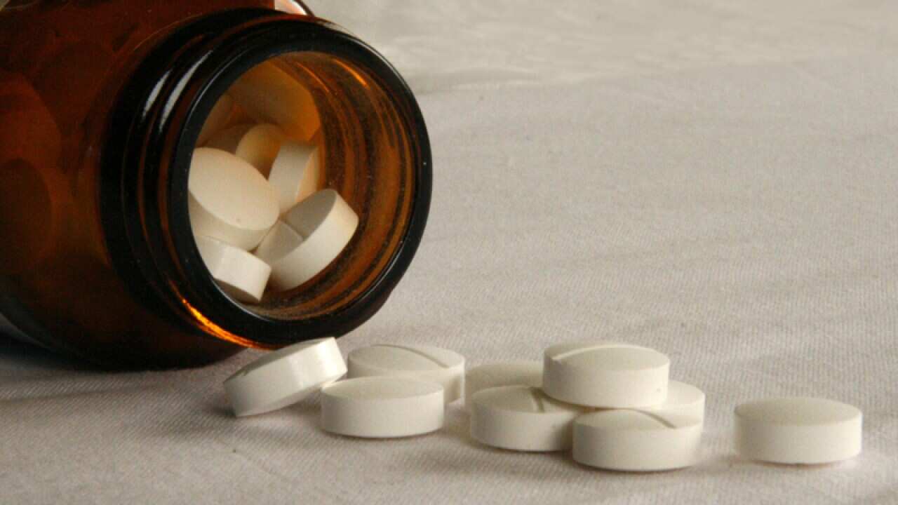 Tablets fall from a jar