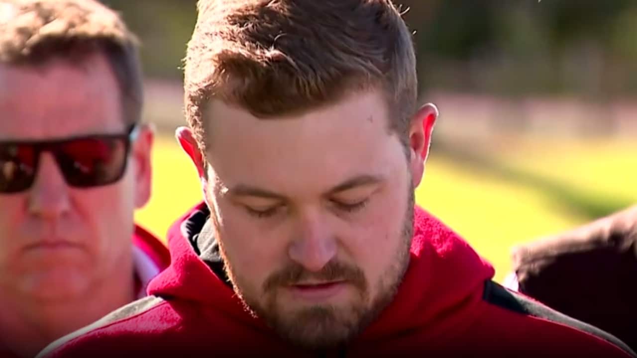 A man speaks at a press conference.