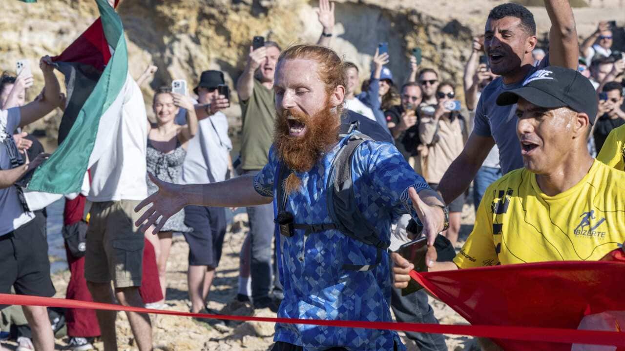 A man running on sandy terrain