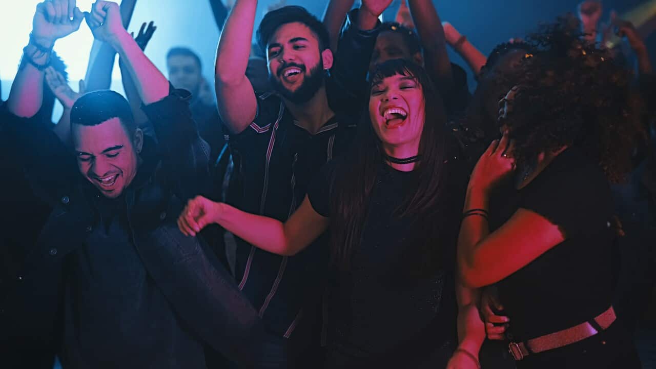 Cropped shot of a group of energetic young friends dancing at a party in a nightclub