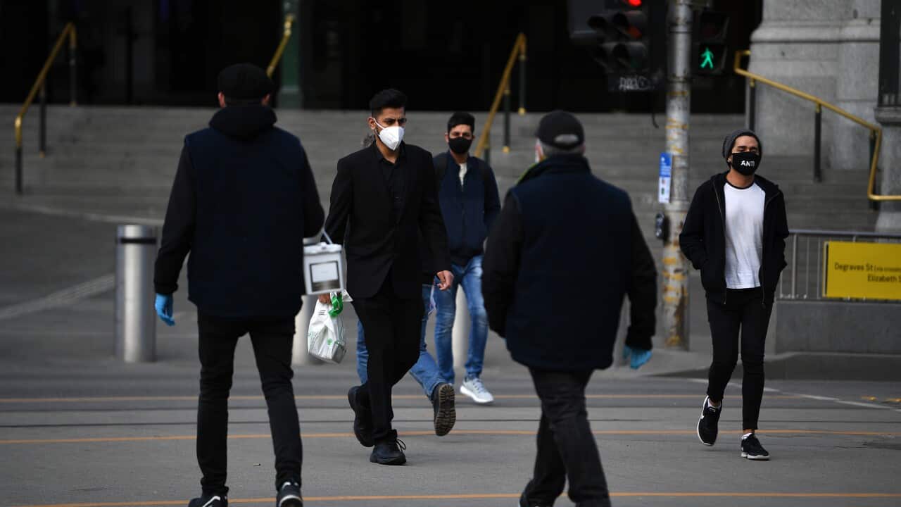 People are seen wearing face masks outside of Flinders Street Station in Melbourne, Thursday, July 23, 2020