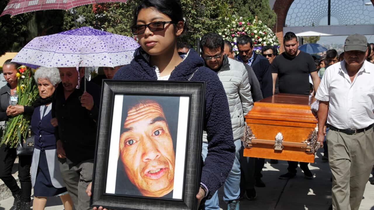 Mourners attend a funeral for victims of a fireworks market explosion