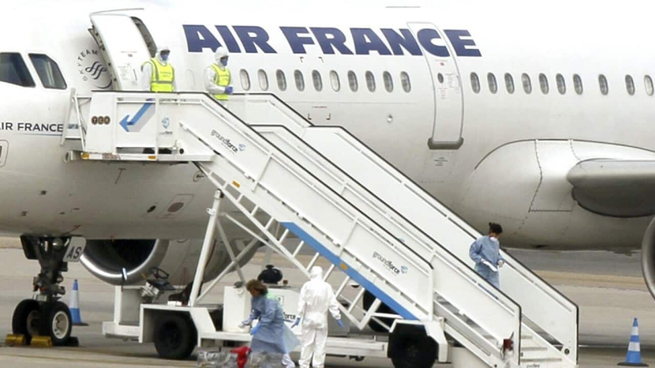 Medical staff next to an Air France plane in Madrid